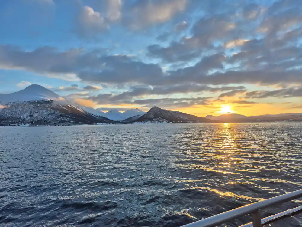 Dramatic orange sunset behind twin snow-capped peaks