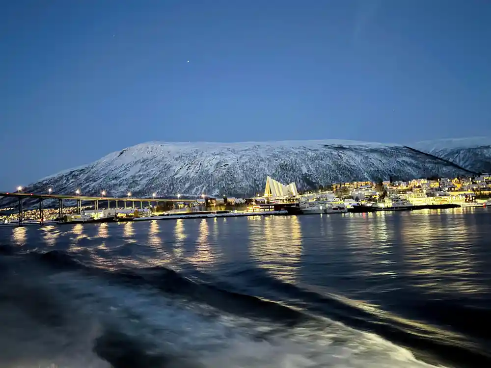 Waterfront town with yellow buildings and snow mountain