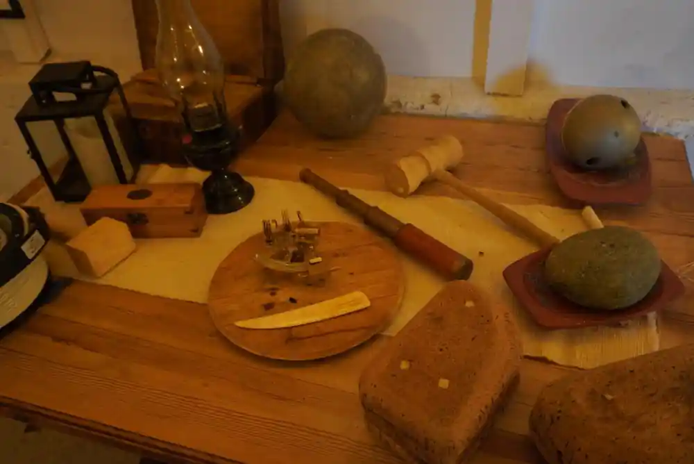Wooden table with fishing equipment and spherical buoys displayed